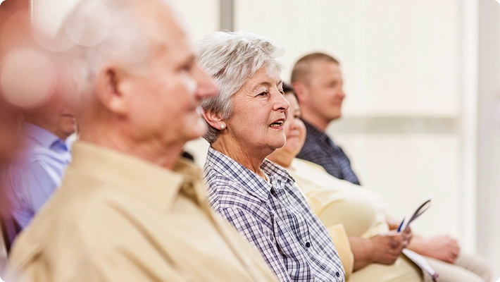 Older woman living in a retirement village working on her laptop from her home office.